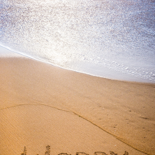 "The word WORRY written in the sand" stock image