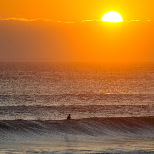 "Surfing at sunset" stock image