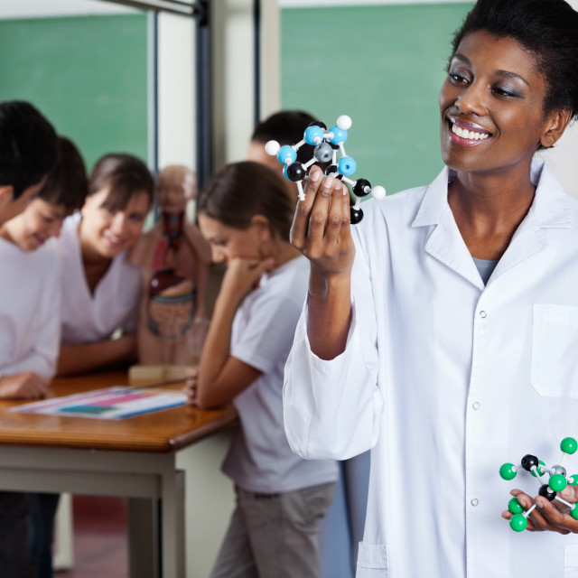 "Female Teacher Looking At Molecular Structure" stock image