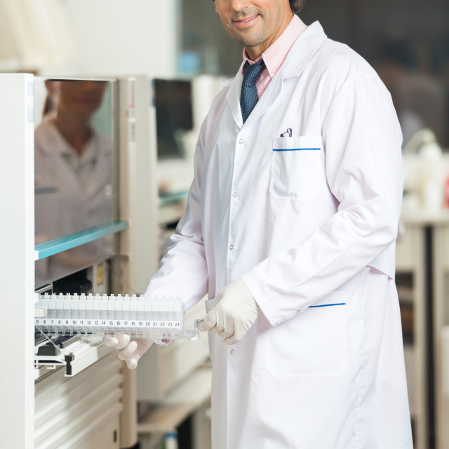 "Technician Loading Samples In Analyzer" stock image