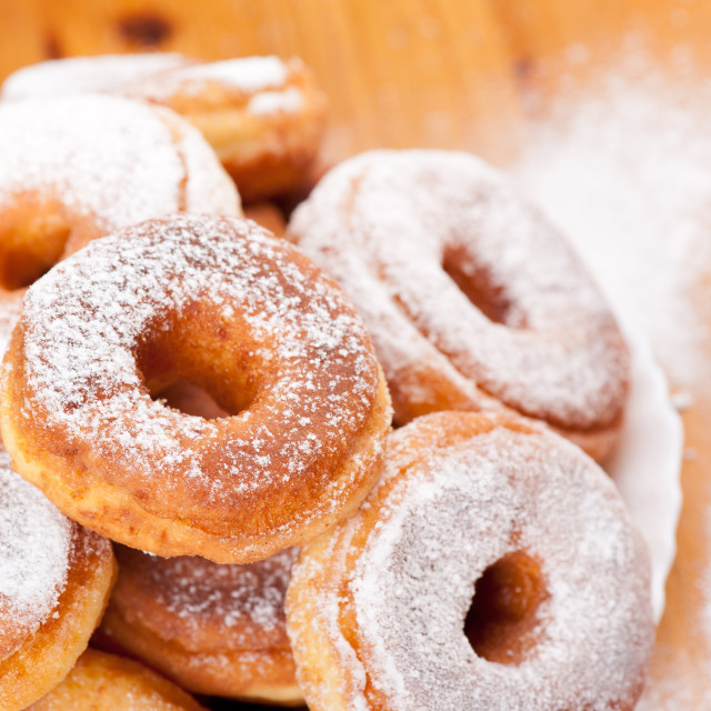 "donuts with holes and powdered sugar" stock image