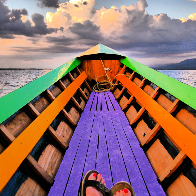 Dreamlike image of rowingboat heading towards horizon License