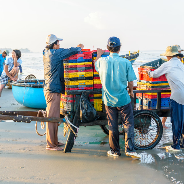 "People's daily life at fishing village Long Hai, they collecting fresh fishes from boat and open up a market in the early morning" stock image