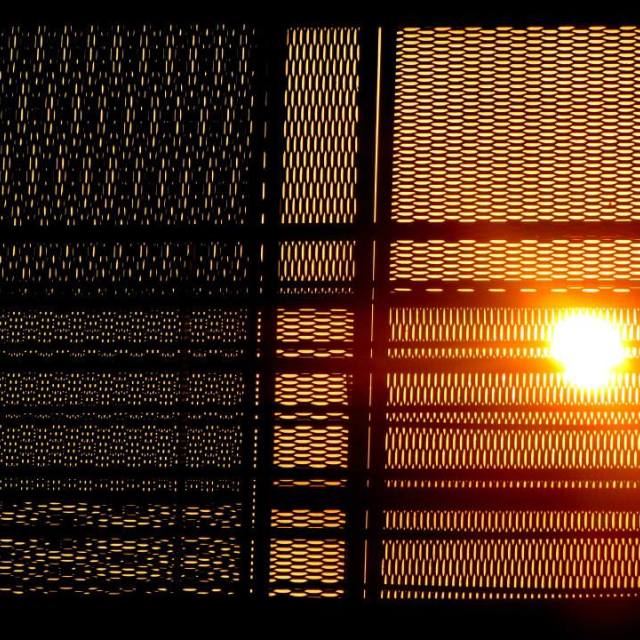 "Sunrise through the fence" stock image