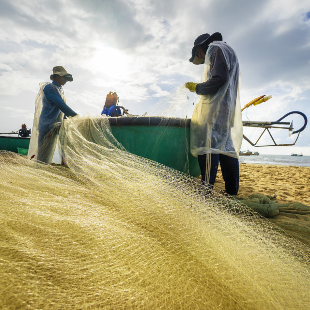 "fisherman working at the beach" stock image