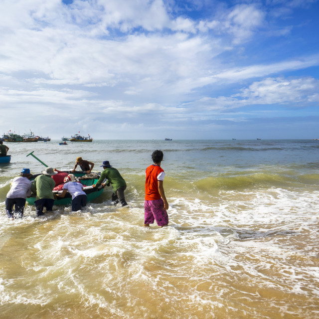 "Fishermans moving basket boat in beach" stock image