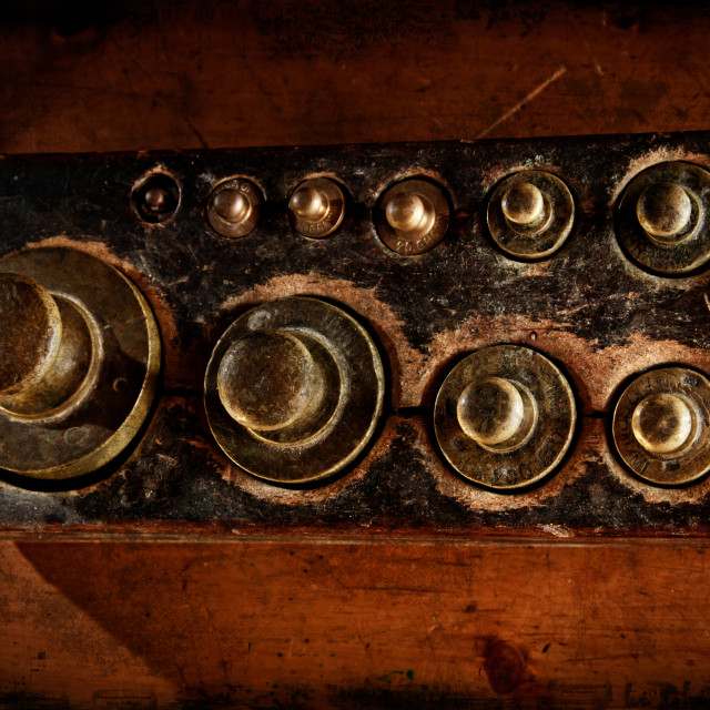 "Antique scales brass weights seen from above. Distressed texture for a retro..." stock image