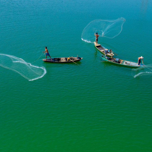 "Throwing fishing net at the lake" stock image