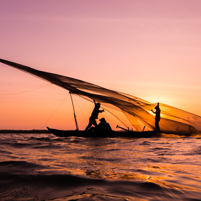 "People try to hold the fishing net in the sunset" stock image