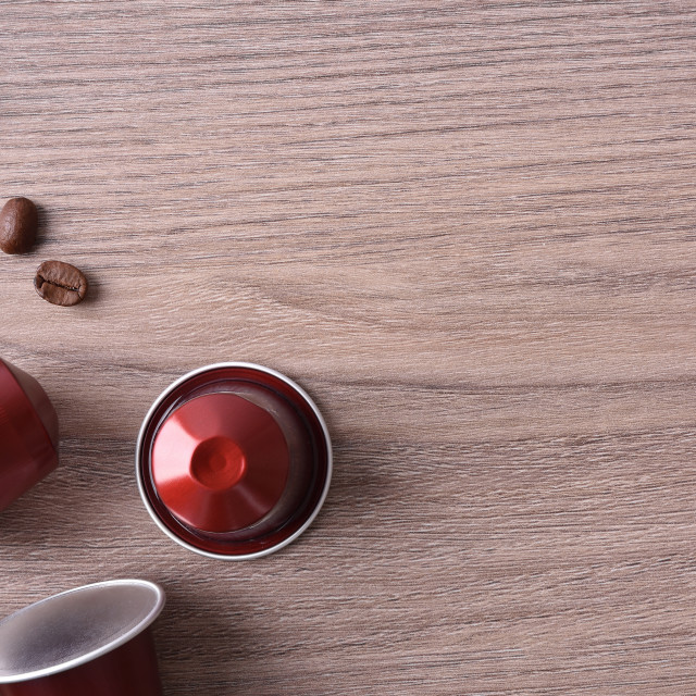 "Three capsules espresso coffee on wooden table top view" stock image