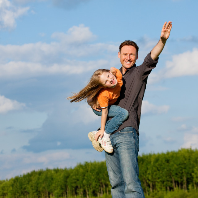 "Father and child playing together" stock image. 