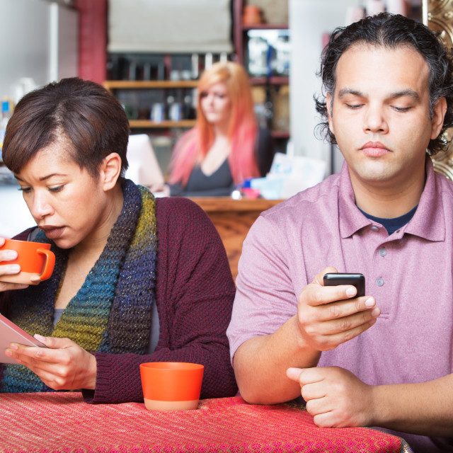 "Distracted Couple Using Devices" stock image