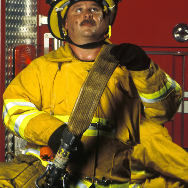 "Fireman with fire hose." stock image
