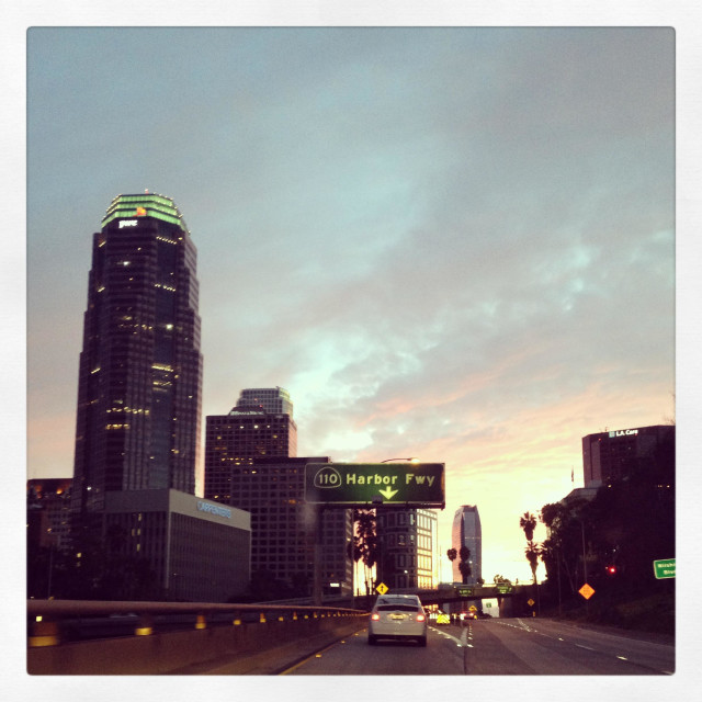 "View of downtown Los Angeles skyline at sunset on the 110 southbound freeway" stock image