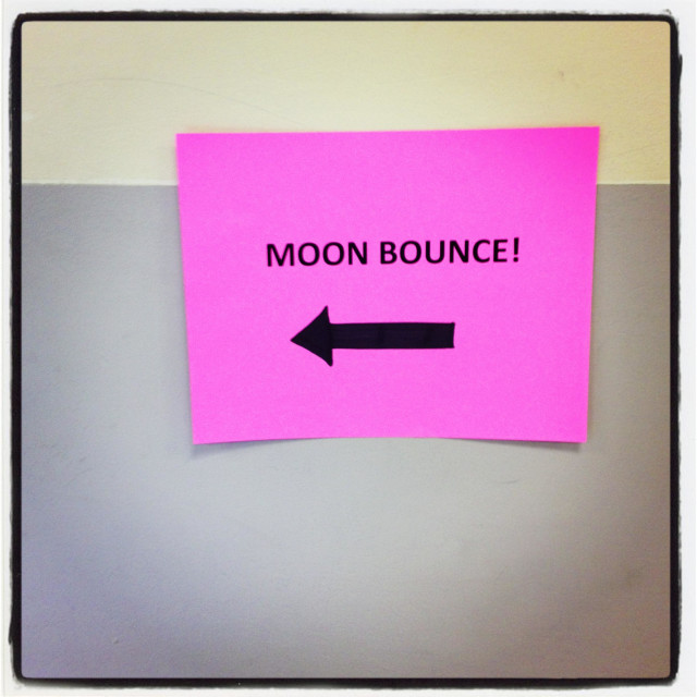 "A sign directing to a moon bounce." stock image