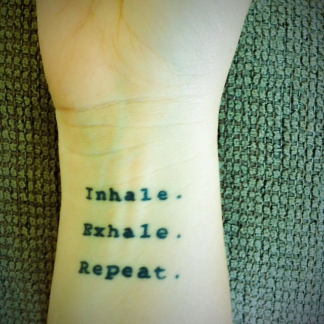 Inhale, exhale, repeat tattoo.