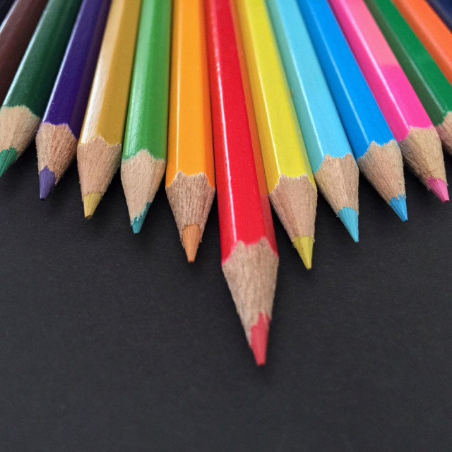 "Close up of coloured pencils in a staggered row" stock image