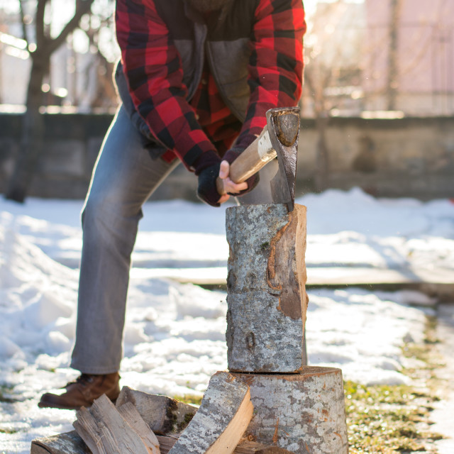 "Man chopping firewood in the yard" stock image
