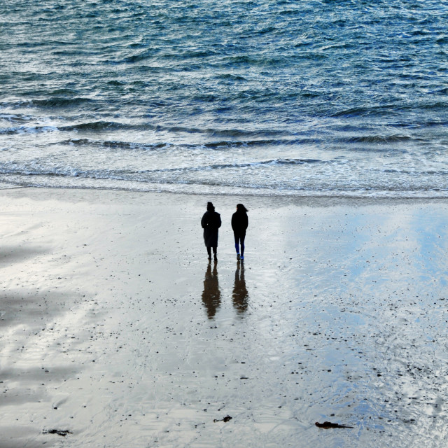 "Couple walking in St Ives Bay" stock image