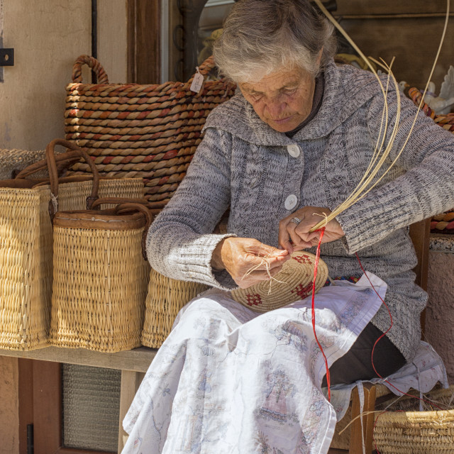 "A woman weaving a basket in Castelsardo" stock image