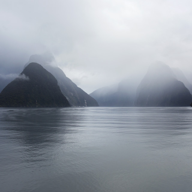 "View down rainswept Milford Sound, mountains obscured by cloud, Milford..." stock image