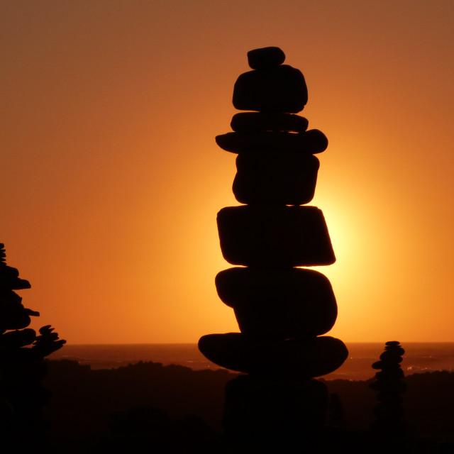 "Zen rocks at sunset silhouettes" stock image