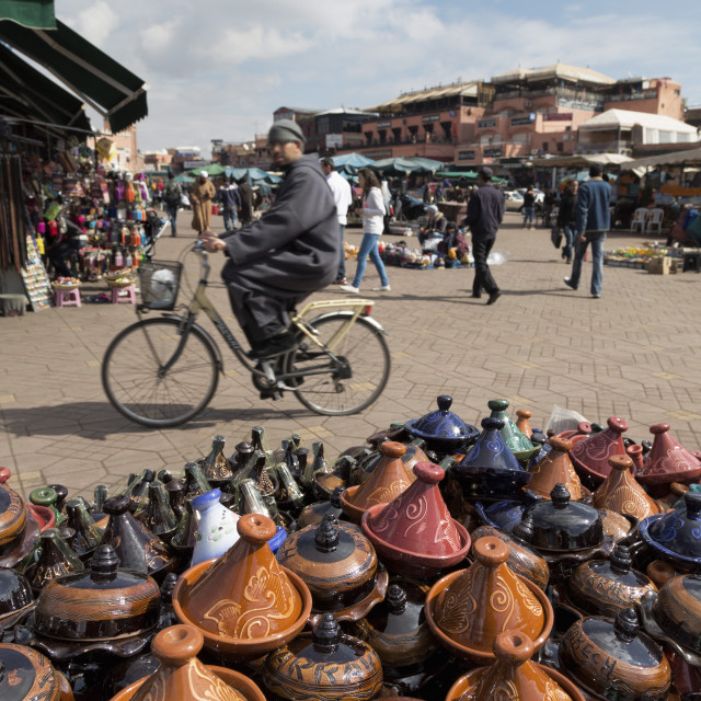 "Cyclist passing a stall selling traditional clay tajine cooking pots in Place..." stock image
