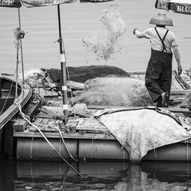 "A Man throwing a fishing net" stock image