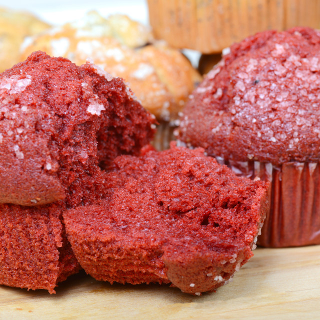 "Red Velvet muffins surrounded by other types of fresh muffins" stock image