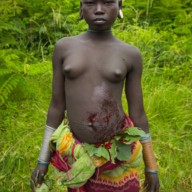 "Proud Suri Tribe Girl Showing The Scarifications On Her Belly Covered By..." stock image