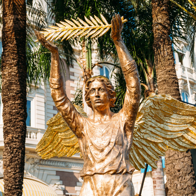 "ronze statue of an angel with a palm branch in Cannes, France" stock image