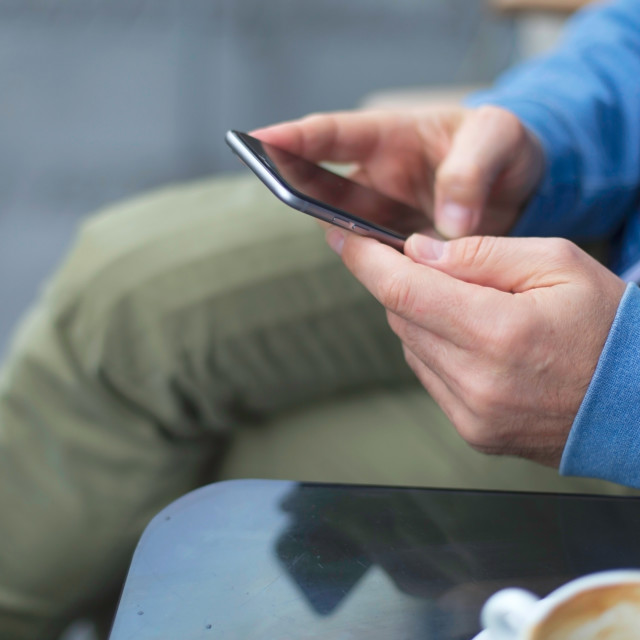 "Man uses his cell phone" stock image