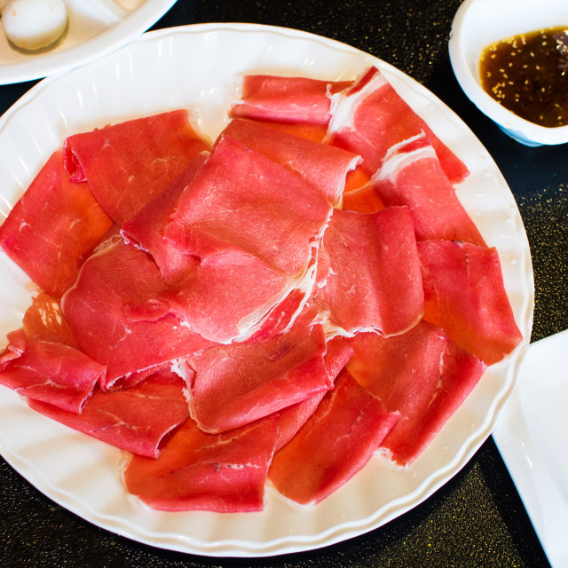 "Sliced meat on a plate ready for hotpot" stock image