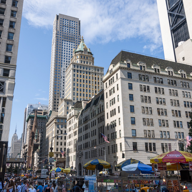 "New York City, USA - June 6, 2010: Street scene in the Fifth Avenue, with people walking in the street and hot dog vendors, in the city of New York, USA." stock image