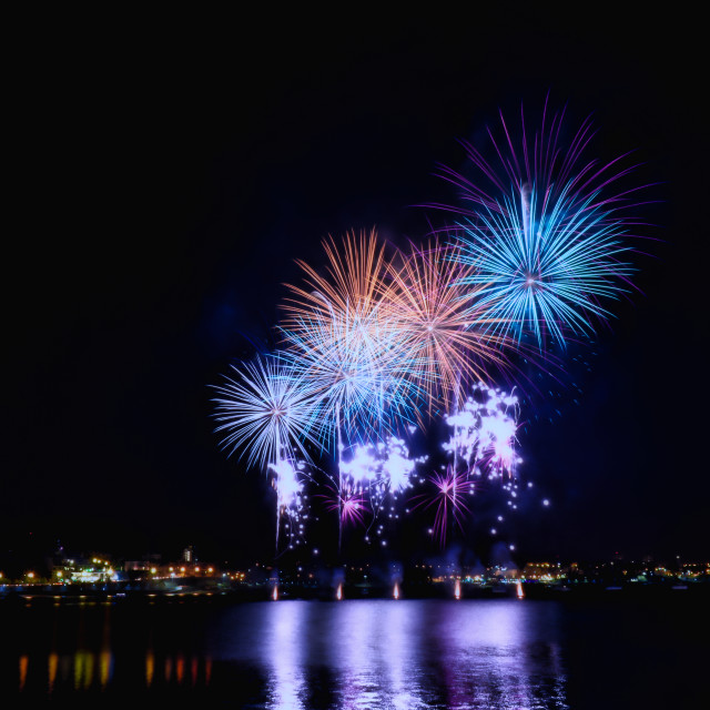 "Fireworks in the water at night" stock image