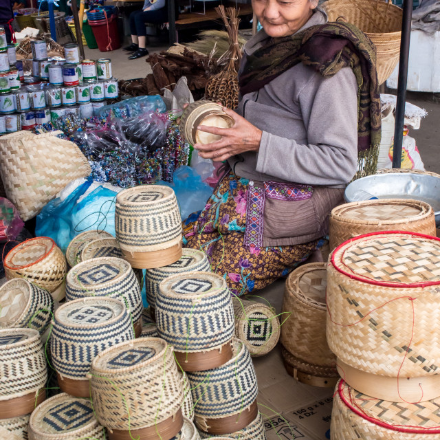 "Woman selling baskets for sticky rice in central outdoor market, Luang..." stock image