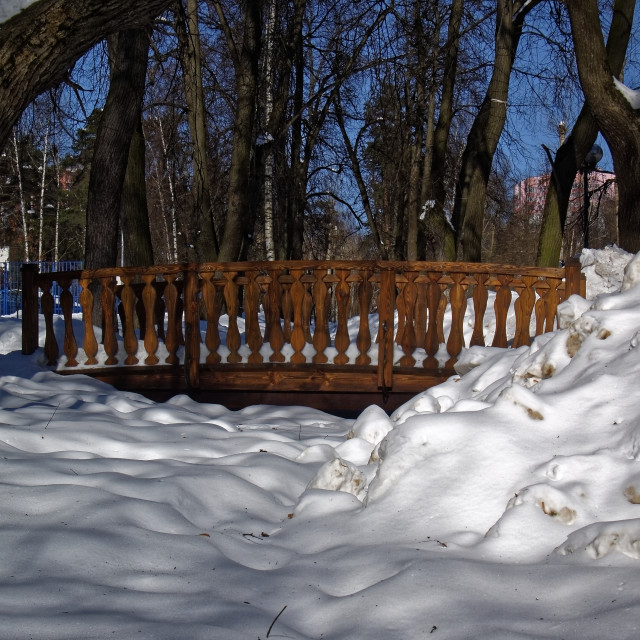 "wooden bridge in the Park across the stream in the snow" stock image