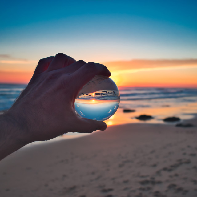 "Cristal Ball Holding on Beach Sunset" stock image