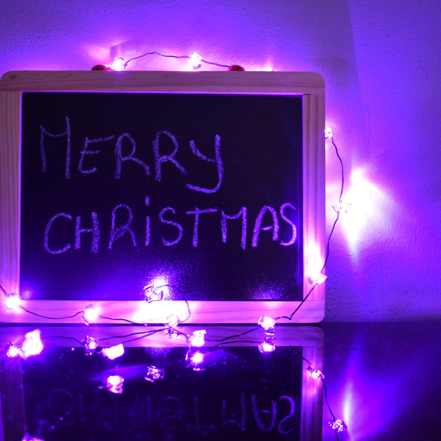 "Merry christmas in chalkboard with lights" stock image