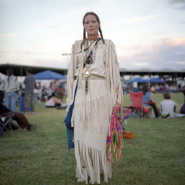 Portrait of woman wearing traditional Native American clothing at a pow