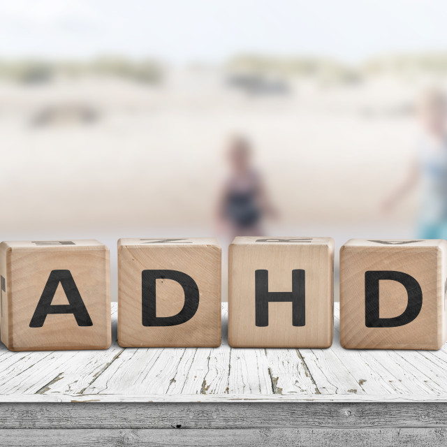 "ADHD sign on a wooden table with kids" stock image