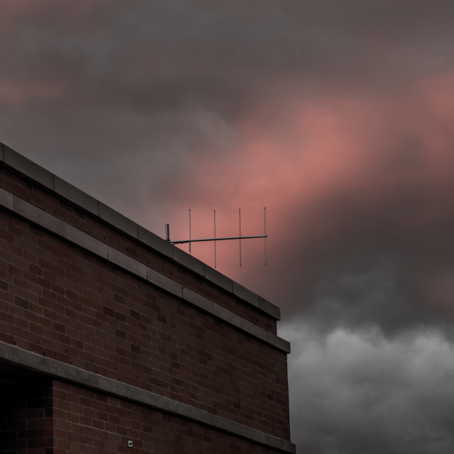 "TV ANTENNA AGAINST CLOUDS ORANGE IN THE SETTING SUN" by JOHN MOUNT - $25.14 "TV ANTENNA AGAINST CLOUDS ORANGE IN THE SETTING SUN" stock image