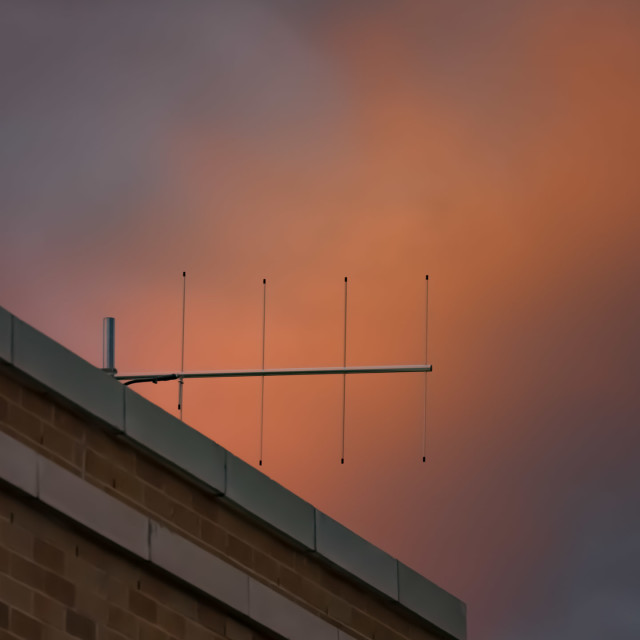 "TV ANTENNA AGAINST CLOUDS ORANGE IN THE SETTING SUN" by JOHN MOUNT - $25.14 "TV ANTENNA AGAINST CLOUDS ORANGE IN THE SETTING SUN" stock image