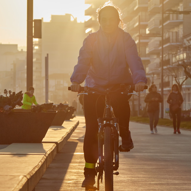 "Girl biking in nice sunny back light" stock image