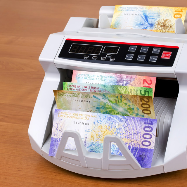 "New Swiss Francs in a counting machine" stock image