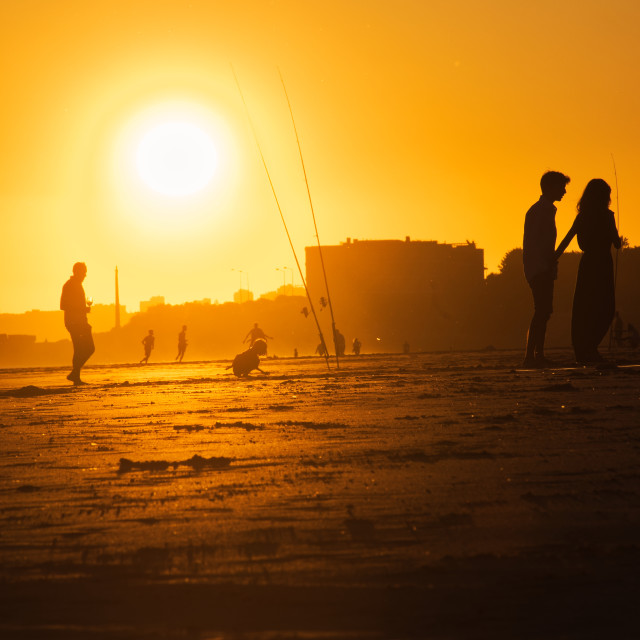 "Portugal Carcavelos Beach - People silhouettes at sunset on the beach in the golden hour" stock image