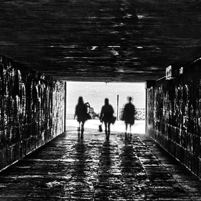 "People walking on the tunnel shadows and silhouettes" stock image