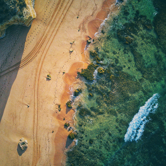 "Aerial view of beach water and sand morning light" stock image