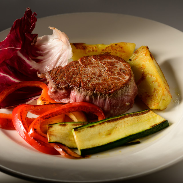 "roasted beef steak with vegetable decorated and searved on a plate" stock image