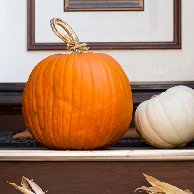 "Three Pumpkins on a Welcome Doormat in Front of a White Door" stock image